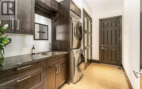 Laundry room with stacked washer / dryer and cabinet space - 24 Jacob Gingrich Drive, Kitchener, ON - Indoor Photo Showing Laundry Room
