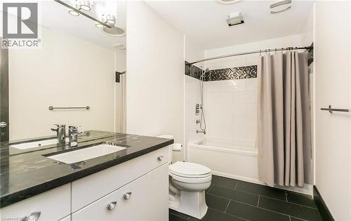 Bathroom with vanity, shower / tub combo, and dark tile patterned flooring - 24 Jacob Gingrich Drive, Kitchener, ON - Indoor Photo Showing Bathroom