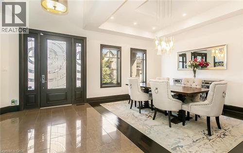Dining room with a raised ceiling, hanging lights, and wood finished floors - 24 Jacob Gingrich Drive, Kitchener, ON - Indoor Photo Showing Dining Room