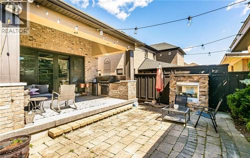View of patio with an outdoor kitchen, an outdoor stone fireplace, and french doors - 24 Jacob Gingrich Drive, Kitchener, ON - Outdoor With Deck Patio Veranda With Exterior