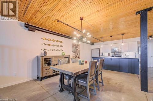 Dining area featuring wooden ceiling and concrete flooring - 85 Spruce Street Unit# 103, Cambridge, ON - Indoor Photo Showing Dining Room