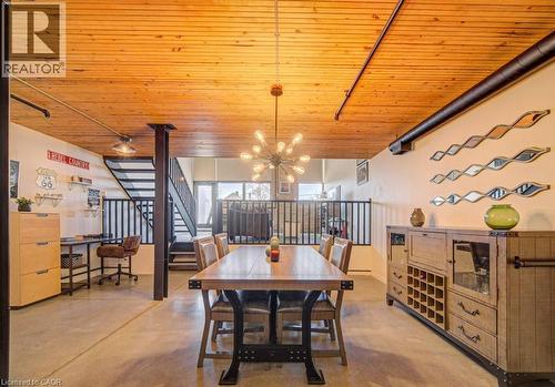Dining space with concrete floors, a chandelier, and wooden ceiling - 85 Spruce Street Unit# 103, Cambridge, ON - Indoor Photo Showing Dining Room