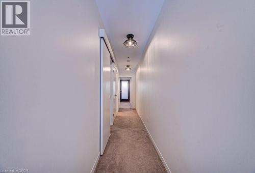 Hallway featuring light colored carpet and baseboards - 85 Spruce Street Unit# 103, Cambridge, ON - Indoor Photo Showing Other Room