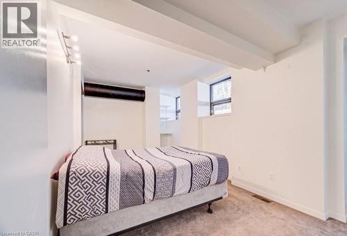 Bedroom with light carpet and baseboards - 85 Spruce Street Unit# 103, Cambridge, ON - Indoor Photo Showing Bedroom