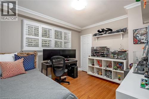 Bedroom with crown molding, light wood-style floors, and a desk - 220 Townsend Avenue, Burlington, ON - Indoor