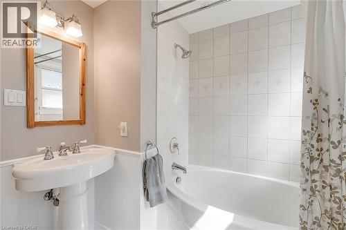 Bathroom featuring shower / bath combo with shower curtain and a wainscoted wall - 220 Townsend Avenue, Burlington, ON - Indoor Photo Showing Bathroom