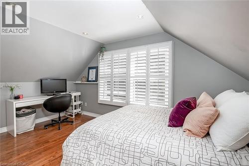 Bedroom with wood finished floors, recessed lighting, and an office area - 220 Townsend Avenue, Burlington, ON - Indoor Photo Showing Bedroom