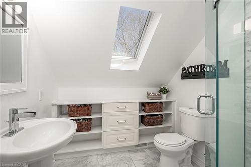 Bathroom featuring a skylight, a shower stall, light marble finish flooring, and vaulted ceiling - 220 Townsend Avenue, Burlington, ON - Indoor Photo Showing Bathroom