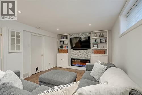 Living area featuring wood finished floors, recessed lighting, and a large fireplace - 220 Townsend Avenue, Burlington, ON - Indoor Photo Showing Living Room With Fireplace