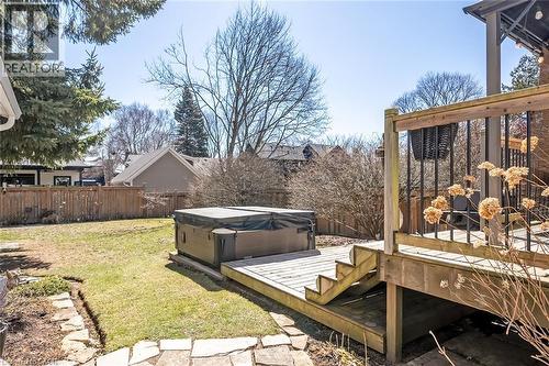 Fenced backyard featuring a wooden deck and a hot tub - 220 Townsend Avenue, Burlington, ON - Outdoor