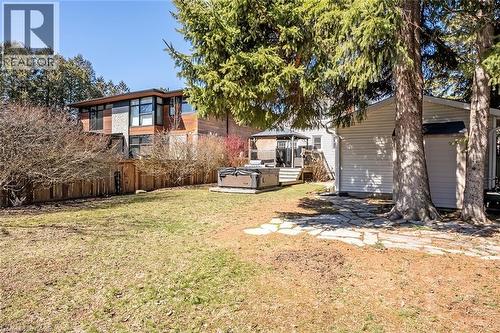 Fenced yard with a hot tub and an outdoor structure - 220 Townsend Avenue, Burlington, ON - Outdoor