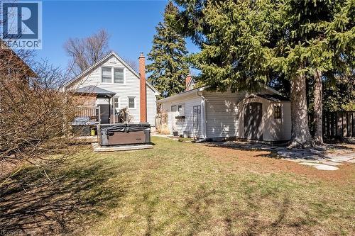 Rear view of house featuring a hot tub, a chimney, and a shed - 220 Townsend Avenue, Burlington, ON - Outdoor