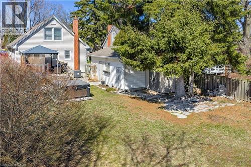 Back of house featuring a fenced backyard, a chimney, and an outbuilding - 220 Townsend Avenue, Burlington, ON - Outdoor