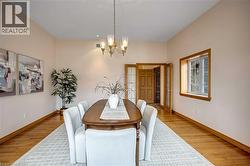 Dining space featuring suspended lighting and light wood-type flooring - 