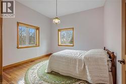 Bedroom featuring baseboards and light wood-type flooring - 