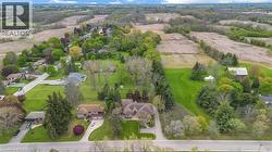 Expansive property featuring lush green lawns and mature trees - 