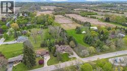 Expansive aerial perspective showcasing a residential street with mature trees and ample green space - 