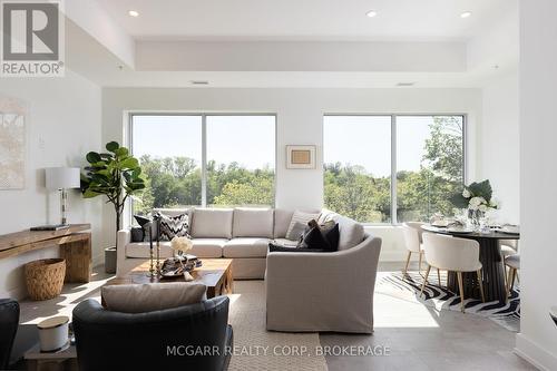 Wall to wall windows - 403 - 77 Yates Street, St. Catharines (Downtown), ON - Indoor Photo Showing Living Room