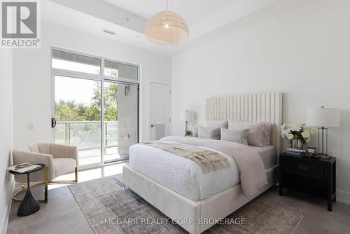 Primary suite with balcony access - 403 - 77 Yates Street, St. Catharines (Downtown), ON - Indoor Photo Showing Bedroom