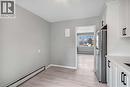 Kitchen featuring a baseboard heating unit, freestanding refrigerator, white cabinetry, light wood-style flooring, and a baseboard radiator - 151 Siebert Avenue, Kitchener, ON  - Indoor 