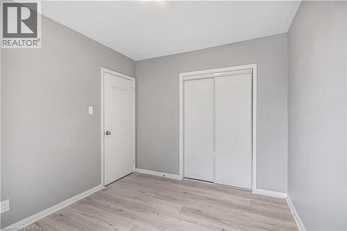 Unfurnished bedroom featuring light wood-style floors and a closet - 151 Siebert Avenue, Kitchener, ON - Indoor Photo Showing Other Room