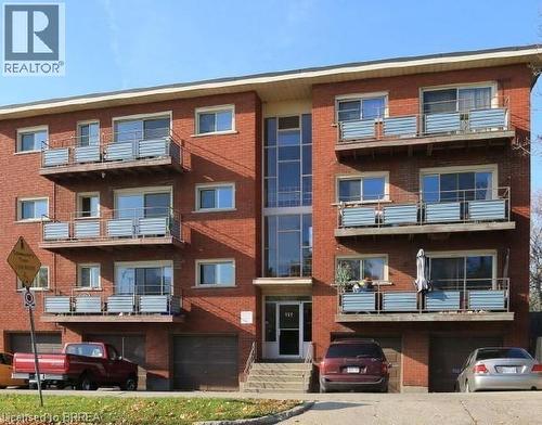 View of apartment building / complex featuring a garage - 151 Siebert Avenue, Kitchener, ON - Outdoor With Balcony With Facade