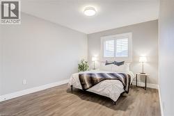 Bedroom featuring light wood-style floors and a textured ceiling - 