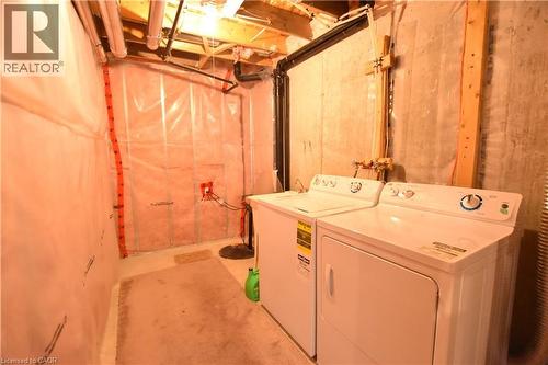 Laundry area featuring unfinished concrete flooring and washer and dryer - 52 Meadowridge Street, Kitchener, ON - Indoor Photo Showing Laundry Room
