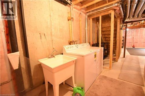 Laundry area featuring concrete floors and washer and clothes dryer - 52 Meadowridge Street, Kitchener, ON - Indoor Photo Showing Laundry Room