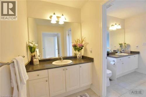Full bath featuring two vanities, light tile patterned floors, and suspended lighting - 512 Terrington Crescent, Kitchener, ON - Indoor Photo Showing Bathroom