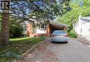 View of front of property featuring driveway, an attached carport, brick siding, and a front yard - 7 Cardill Crescent, Waterloo, ON  - Outdoor 