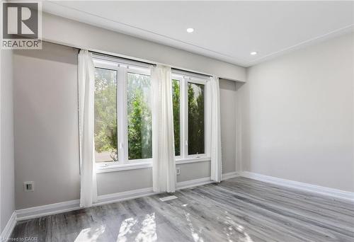 Unfurnished room with light wood-style floors and recessed lighting - 7 Cardill Crescent, Waterloo, ON - Indoor Photo Showing Other Room