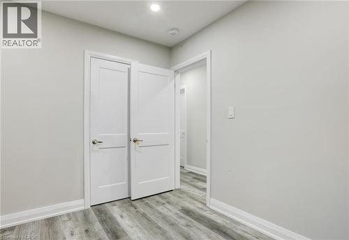 Unfurnished bedroom with baseboards and light wood-type flooring - 7 Cardill Crescent, Waterloo, ON - Indoor Photo Showing Other Room