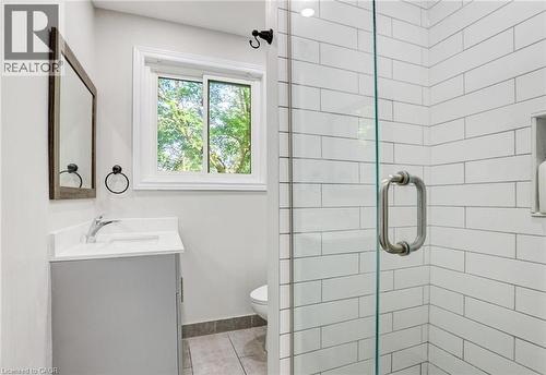 Full bathroom featuring a stall shower, vanity, and light tile patterned floors - 7 Cardill Crescent, Waterloo, ON - Indoor Photo Showing Bathroom