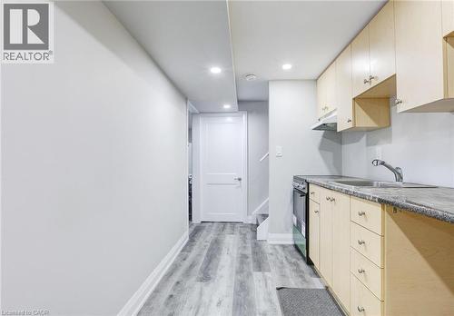 Kitchen with recessed lighting, light wood-style flooring, electric range, and light wood finish cabinets - 7 Cardill Crescent, Waterloo, ON - Indoor Photo Showing Kitchen