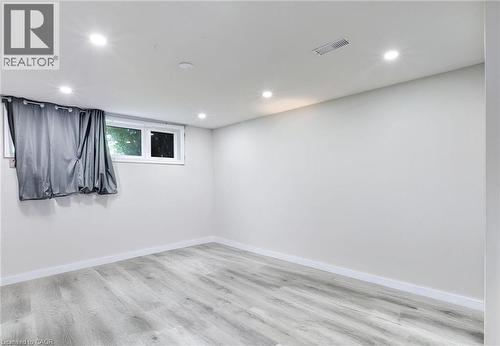 Empty room with recessed lighting and light wood-style flooring - 7 Cardill Crescent, Waterloo, ON - Indoor