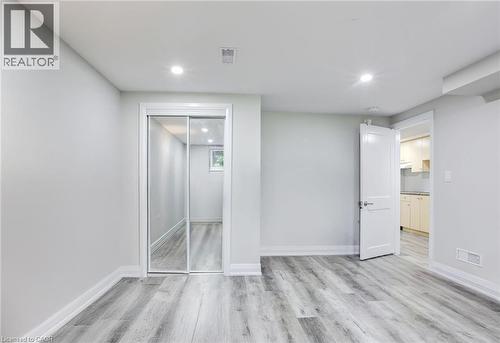 Unfurnished bedroom with recessed lighting, light wood-style floors, and a closet - 7 Cardill Crescent, Waterloo, ON - Indoor Photo Showing Other Room