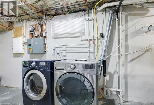 Laundry area featuring concrete flooring, washer and clothes dryer, and electric panel - 7 Cardill Crescent, Waterloo, ON - Indoor Photo Showing Laundry Room