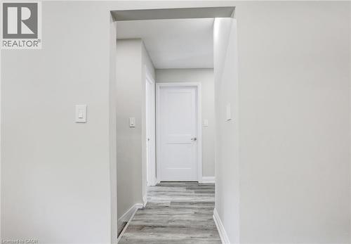 Corridor with light wood-style floors and baseboards - 7 Cardill Crescent, Waterloo, ON - Indoor Photo Showing Other Room