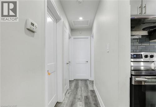 Corridor with light wood-style floors and recessed lighting - 7 Cardill Crescent, Waterloo, ON - Indoor