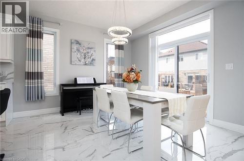 Dining room featuring hanging lights and light marble finish floors - 346 Chokecherry Crescent, Waterloo, ON - Indoor Photo Showing Dining Room