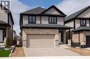 View of front of home featuring driveway, an attached garage, a shingled roof, and brick siding - 346 Chokecherry Crescent, Waterloo, ON  - Outdoor With Facade 