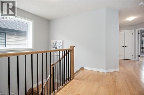 Corridor with light wood-style floors and an upstairs landing - 346 Chokecherry Crescent, Waterloo, ON - Indoor Photo Showing Other Room