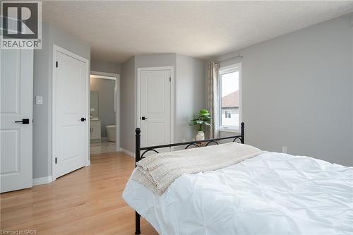 Bedroom featuring light wood-type flooring, a closet, and a textured ceiling - 346 Chokecherry Crescent, Waterloo, ON - Indoor Photo Showing Bedroom