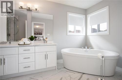 Full bathroom featuring a marble finish shower, double vanity, light marble finish floors, and a freestanding bath - 346 Chokecherry Crescent, Waterloo, ON - Indoor Photo Showing Bathroom