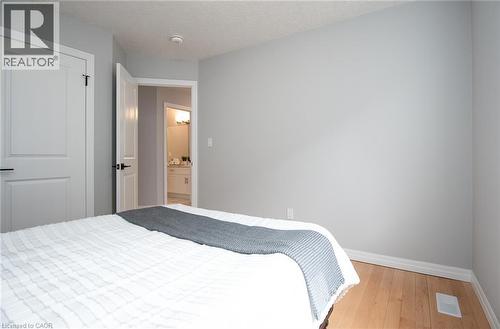 Bedroom with baseboards and light wood-type flooring - 346 Chokecherry Crescent, Waterloo, ON - Indoor Photo Showing Bedroom