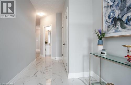 Hall with light marble finish floors and a textured ceiling - 346 Chokecherry Crescent, Waterloo, ON - Indoor Photo Showing Other Room