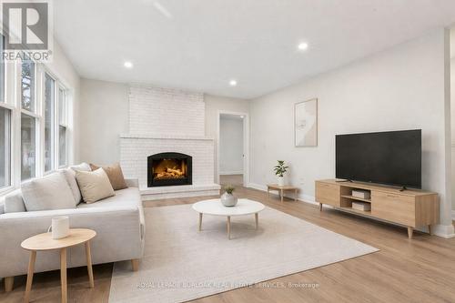 1012 North Shore Boulevard E, Burlington, ON - Indoor Photo Showing Living Room With Fireplace