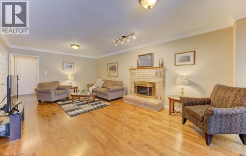 Hardwood flooring - 594 Hunters Place, Waterloo, ON - Indoor Photo Showing Living Room With Fireplace