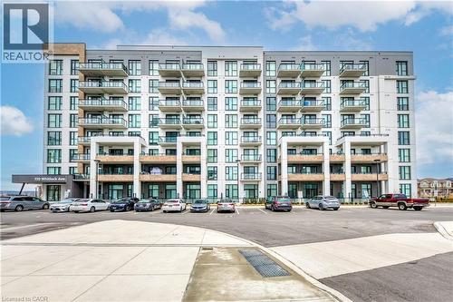 View of apartment building / complex featuring uncovered parking - 770 Whitlock Avenue Unit# 606, Milton, ON - Outdoor With Facade